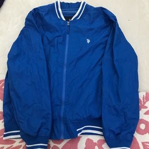 A light weigh jacket w/ a pink polo shirt.